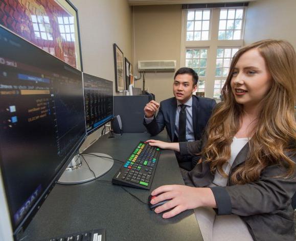 Students managing funds with computers